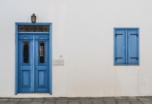 tidy modern entrance with parcel box, minimalist wall light, and clear house number signage